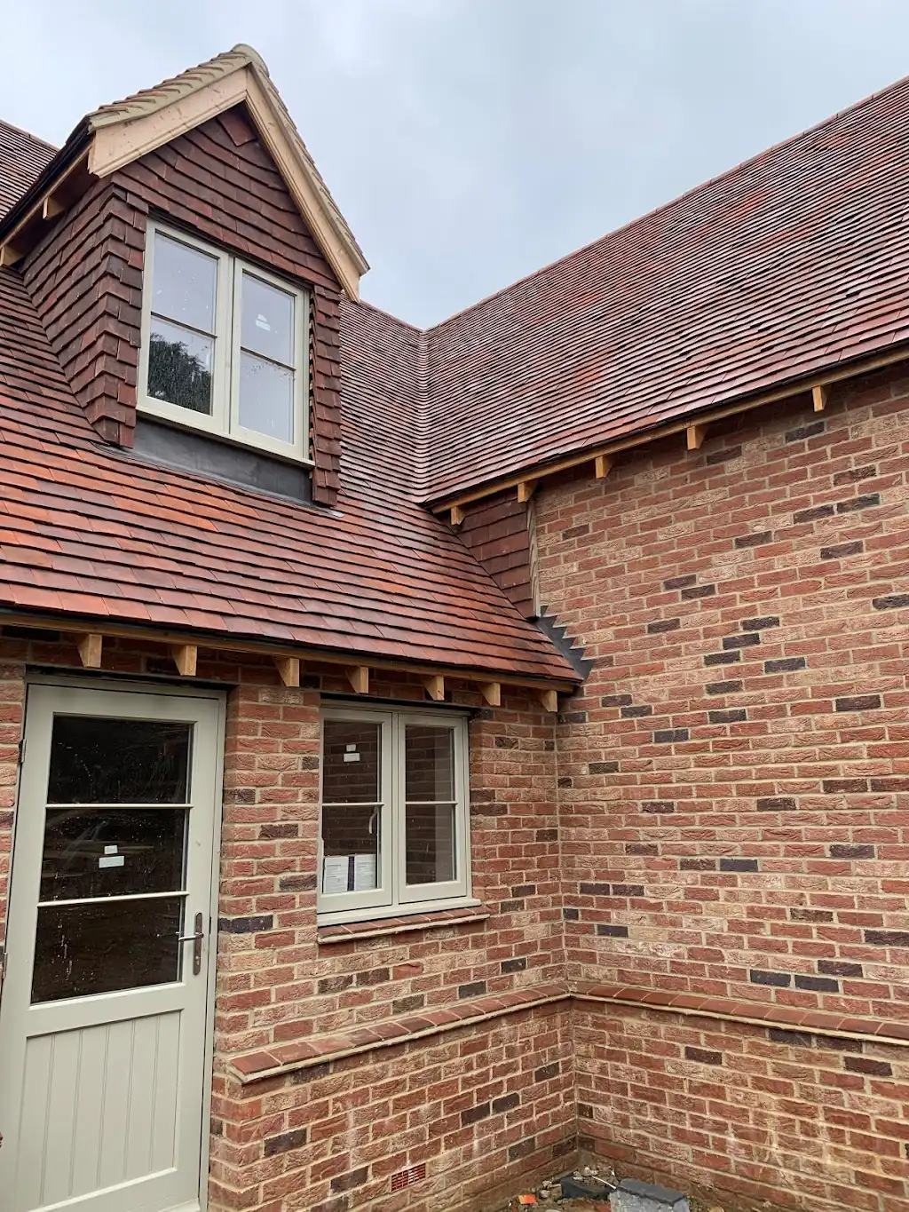 A brick building with a door and windows.
